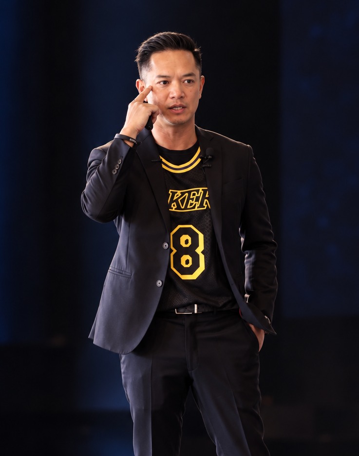 Khai McBride speaking on stage